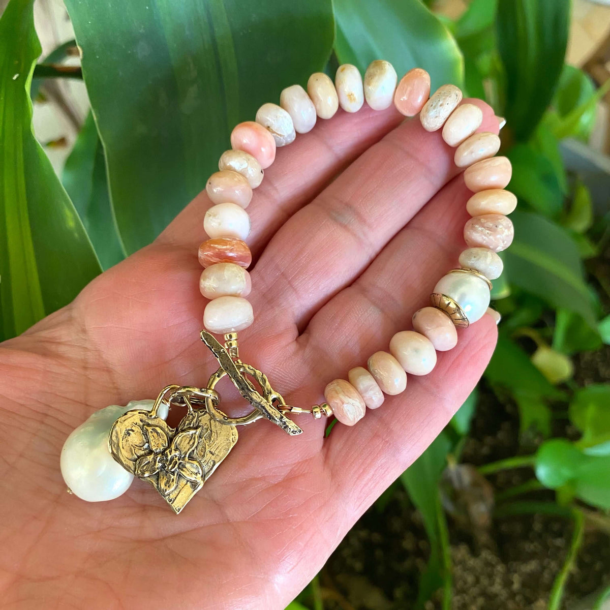 Pink opal bracelet with heart and baroque pearl charm handcrafted with smooth pink opal beads.