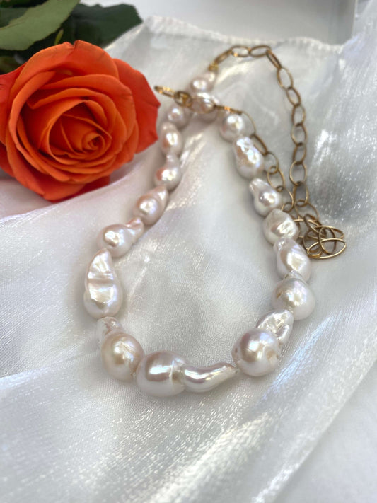 Close-up of baroque pearl gold chain necklace on white background — detailed view of chunky gold chain and lustrous pearls by Loulia Pearl Jewelry
