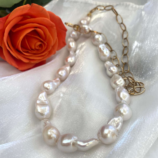 Close-up of baroque pearl gold chain necklace on white background — detailed view of chunky gold chain and lustrous pearls by Loulia Pearl Jewelry