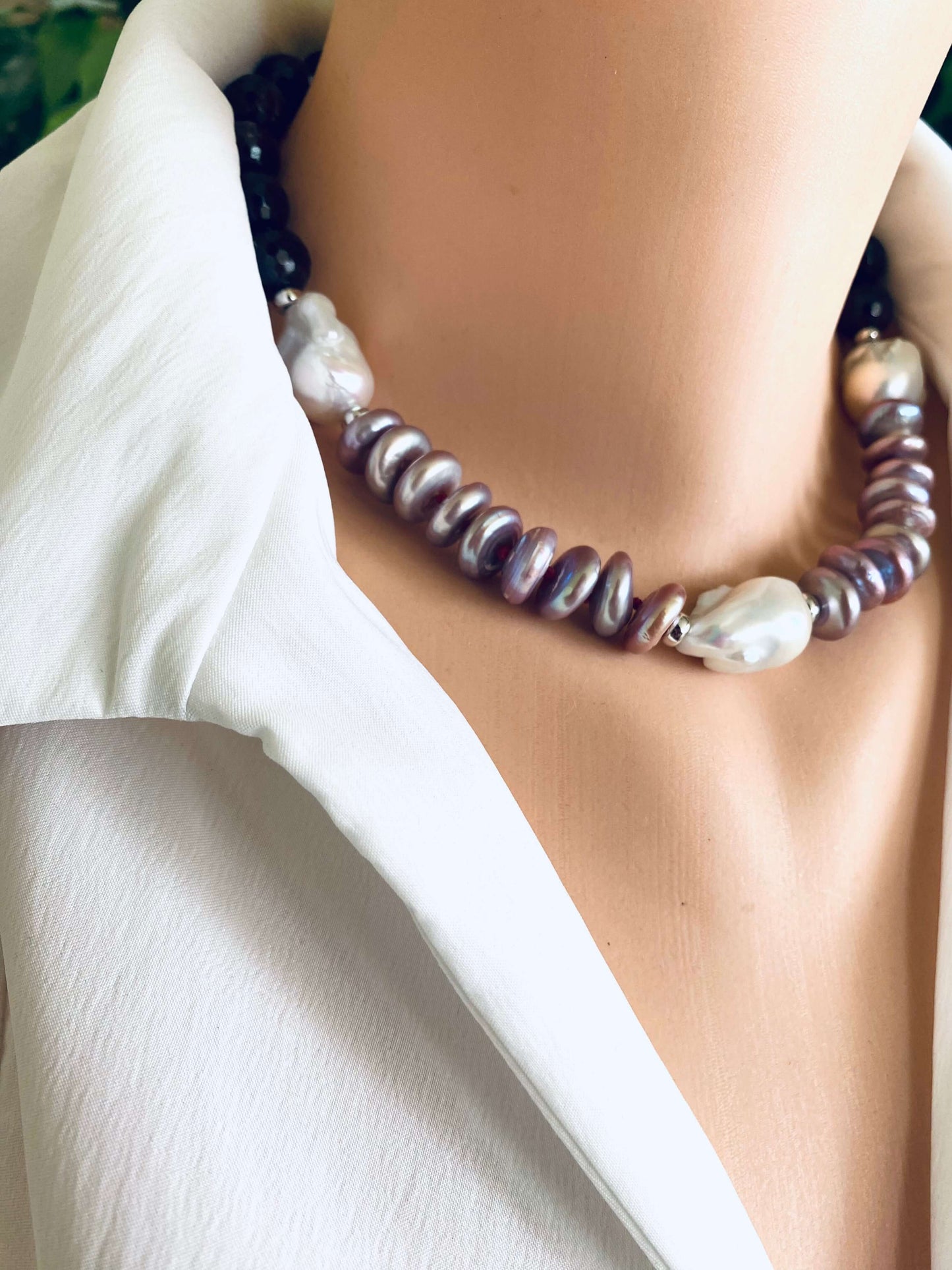 Garnet pearl necklace featuring Baroque and Coin pearls, elegantly displayed on a mannequin wearing a white collared shirt.