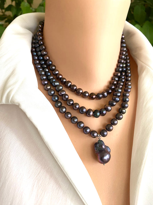 Black pearl necklace on a mannequin with a white background