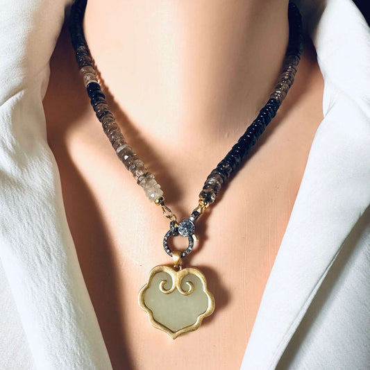 Hotan jade pendant in gold vermeil with natural nephrite charm, displayed on a decorative necklace.