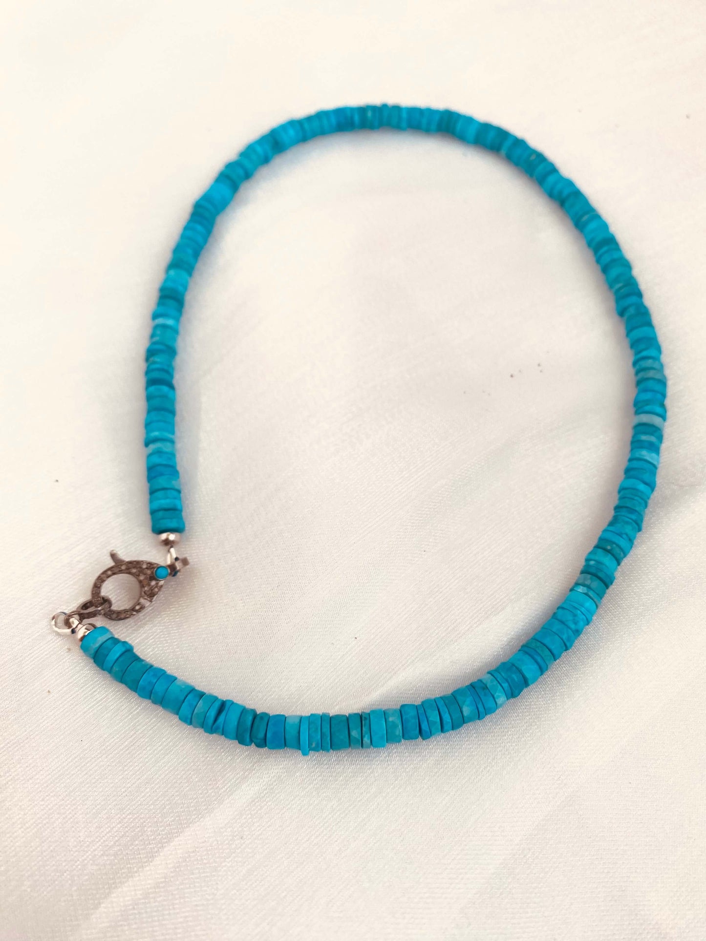 Turquoise howlite beaded necklace with oxidized silver pavé clasp, showcasing vibrant color and artisanal texture.