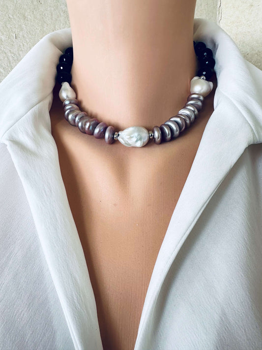 Baroque pearl necklace with black tourmaline and white pearls worn at collarbone