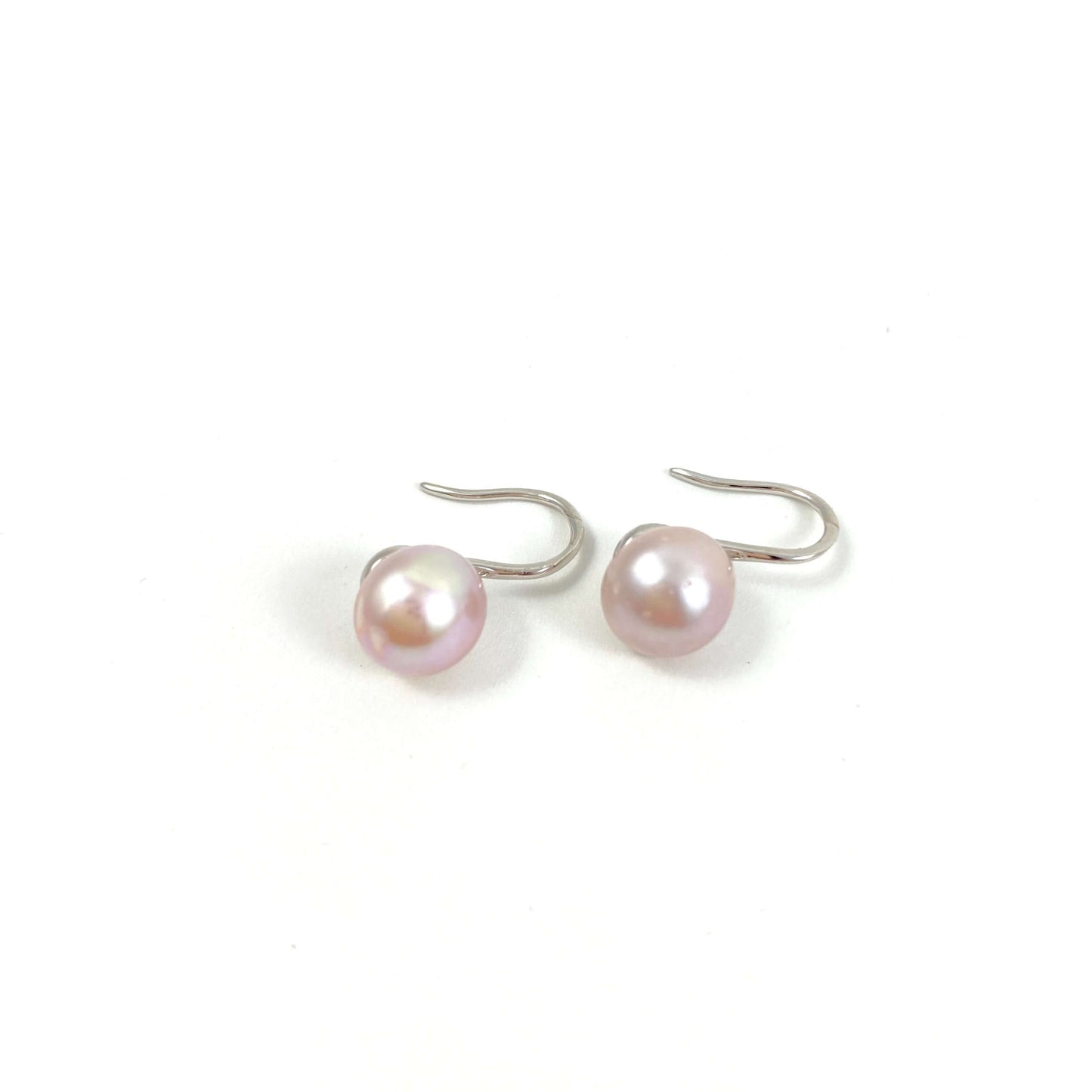 silver high heel earrings with pink pearls on white background