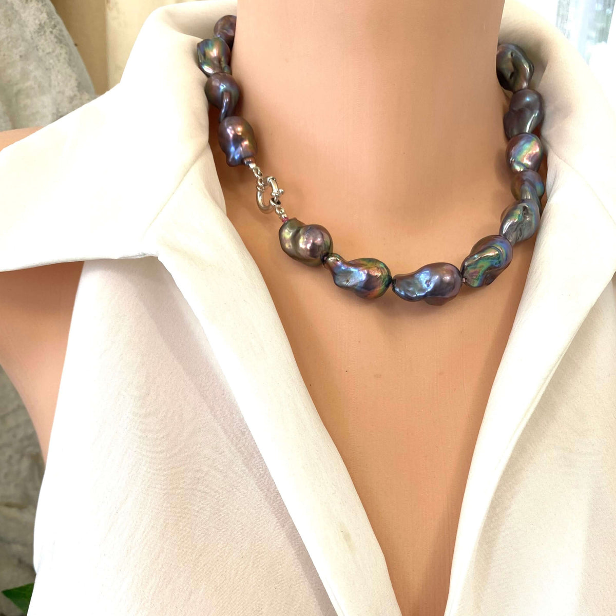 Black Baroque Pearl Necklace featuring unique peacock-black freshwater baroque pearls handcrafted on dark-pink silk.