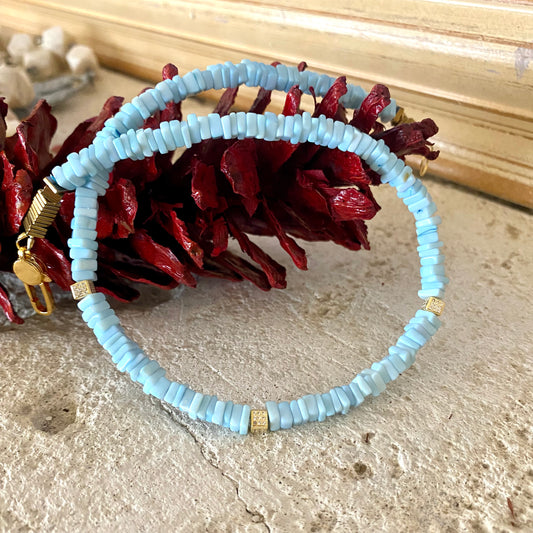 Blue Opal Choker Necklace with Peruvian Opal Beads displayed on a textured surface with red foliage.