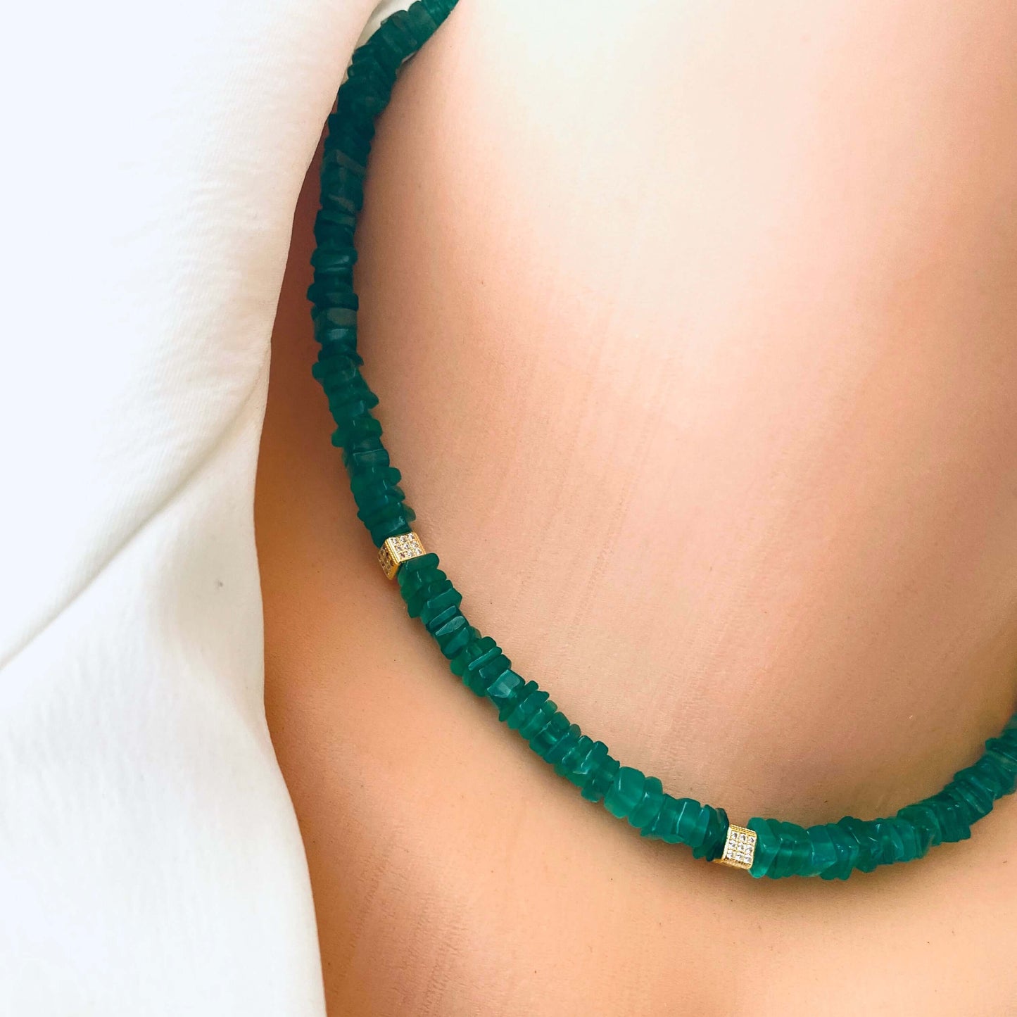 Green onyx choker necklace styled close to the neck with minimalist gold details