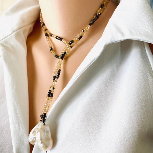 Citrine and baroque pearls lariat necklace featuring faceted citrine rondelles and large baroque pearls.