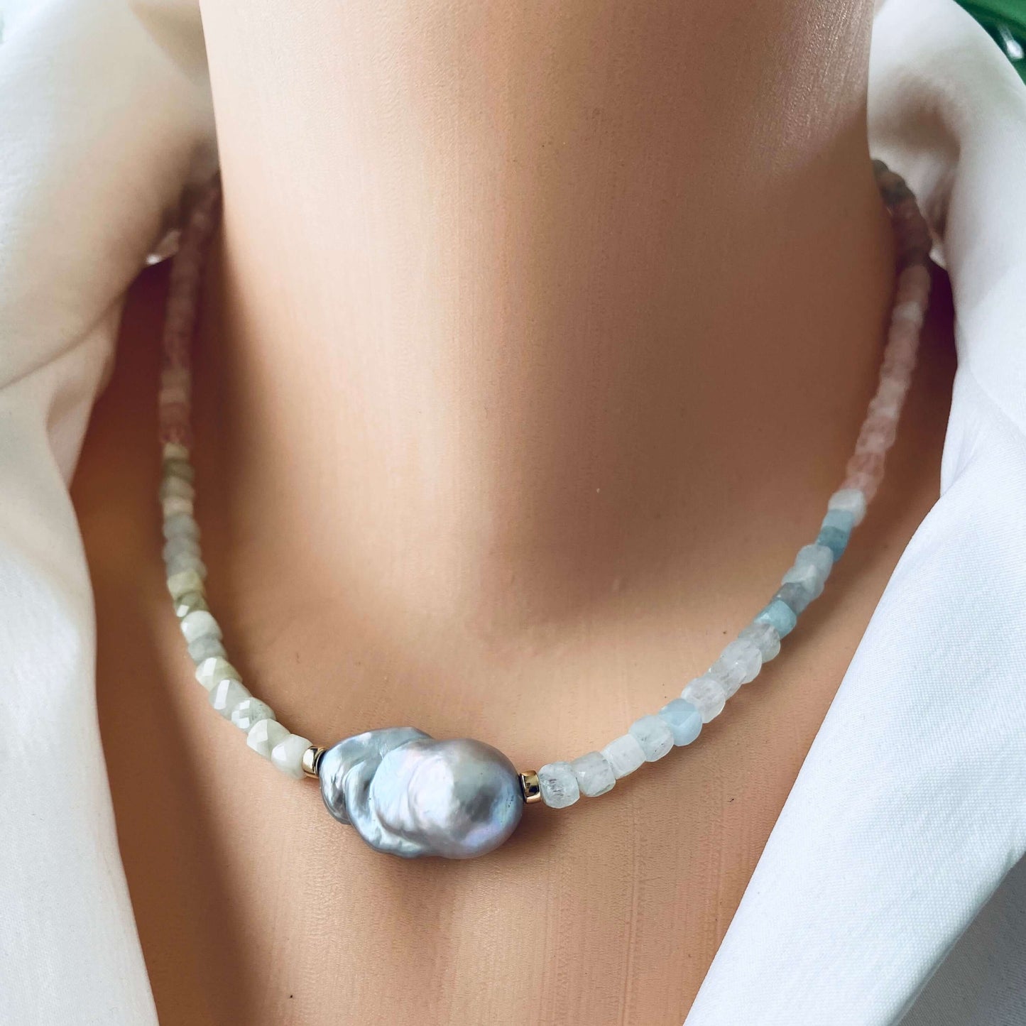 Aquamarine morganite pearl necklace close up showing aquamarine morganite beads and grey pearl