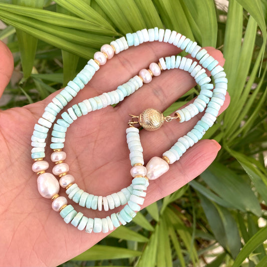 Sky blue opal pearl necklace held in hand with tire-shaped opal beads and freshwater pearls, handmade Canadian jewelry