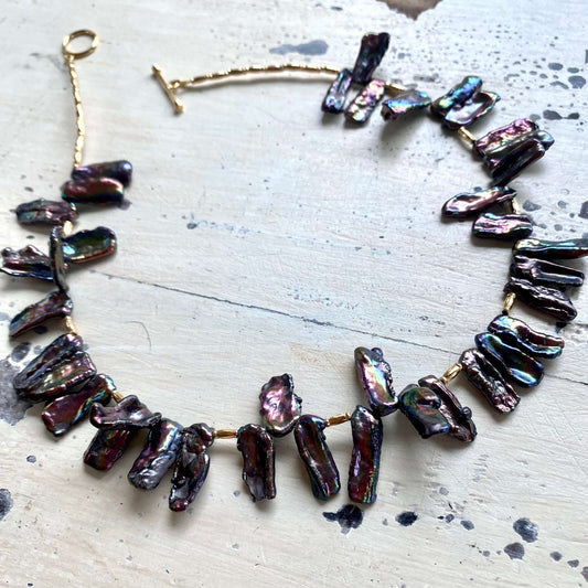 Black pearl choker necklace flat lay, peacock Biwa stick pearl strand with toggle clasp
