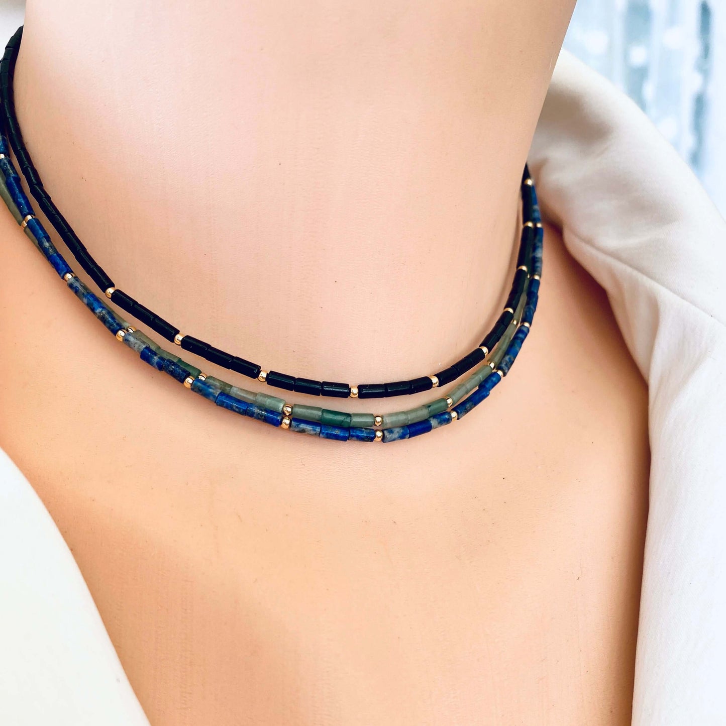 Lapis lazuli onyx choker necklace worn close to neckline with gold filled accents