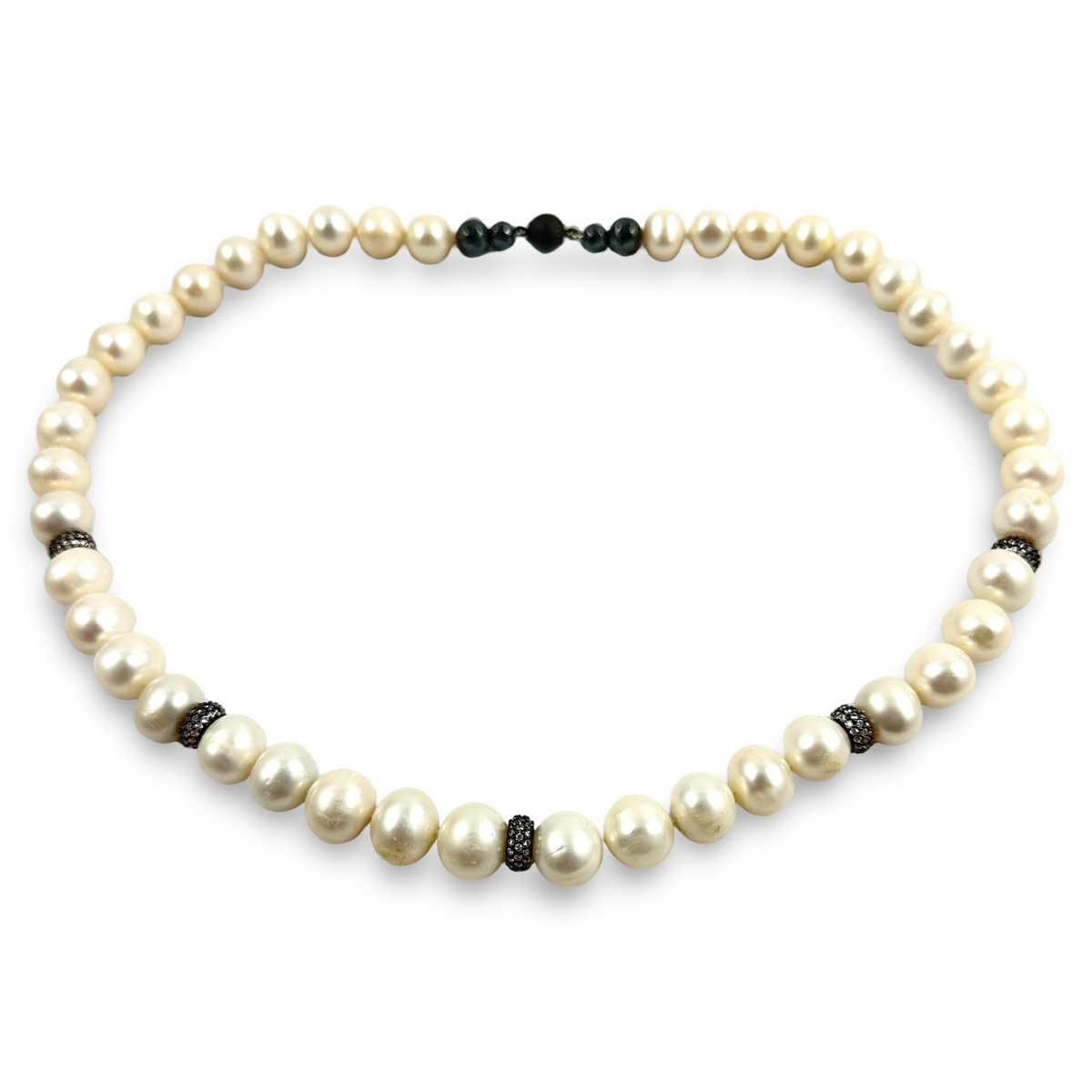 A pearl necklace with large cream-colored freshwater pearls and small dark metallic spacer beads, displayed on a clean white background.