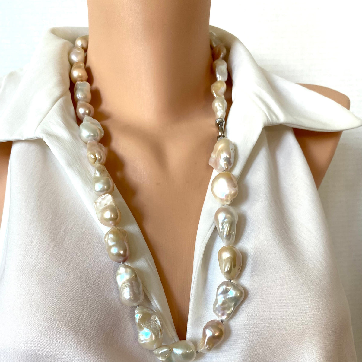 Hand knotted with large freshwater baroque pearls in natural shades of white, ivory, beige and soft blush, this 29-inch necklace brings together dramatic size and effortless versatility.