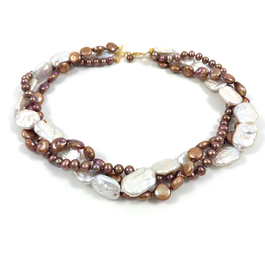 A multi-strand beaded necklace featuring brown and bronze pearls, irregular white baroque pearls, and small metallic gold beads, displayed on a clean white background.