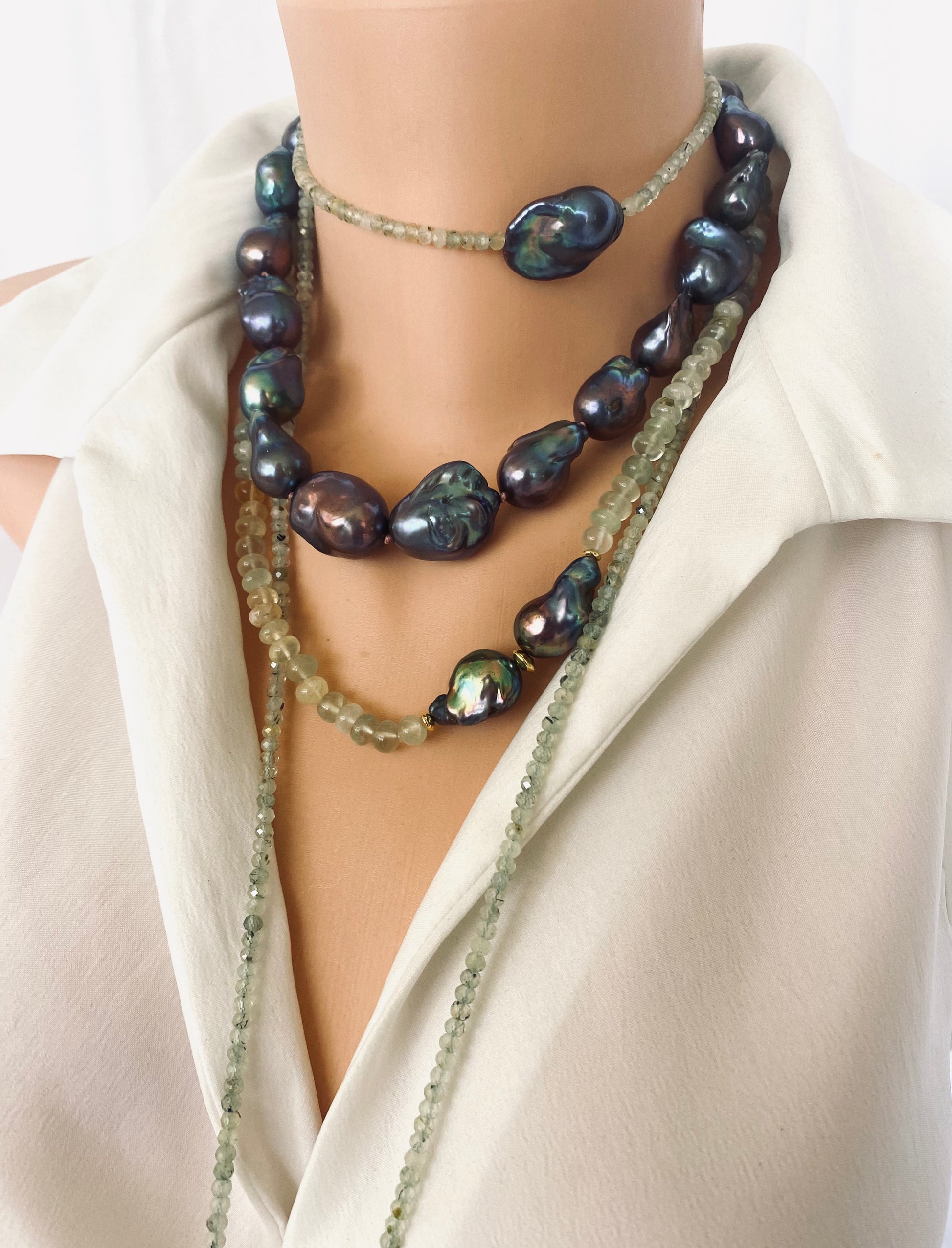 Black Baroque Pearl Necklace | Handcrafted Chunky Design showcasing unique peacock-black pearls on dark-pink silk.