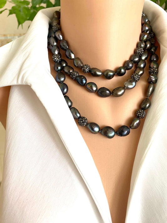 Black pearl necklace on a mannequin with a white blazer