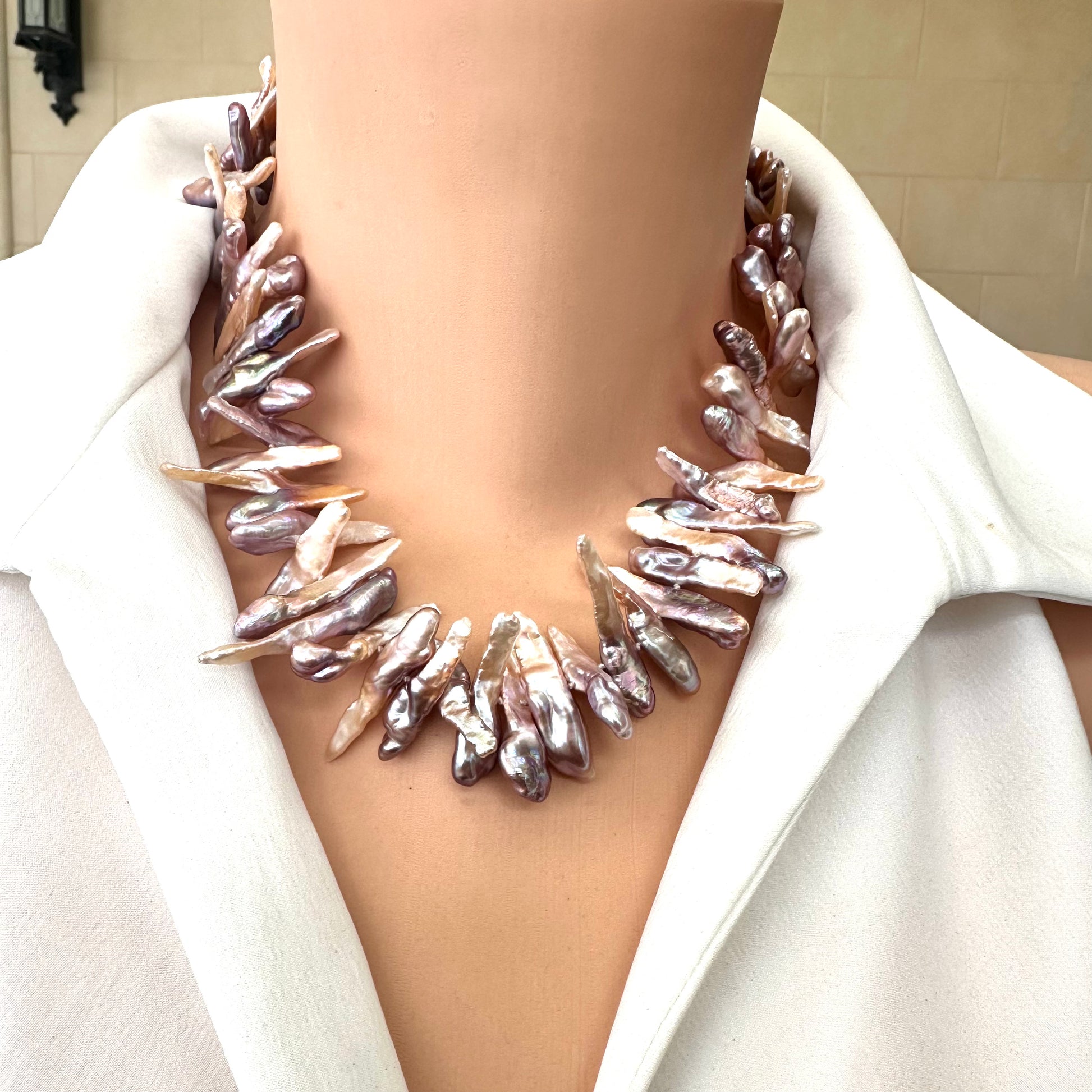 Front view of Biwa Pearl Necklace featuring purplish long stick freshwater pearls on mannequin.