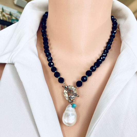 Black tourmaline baroque pearl toggle necklace worn on model showing pearl pendant and charms