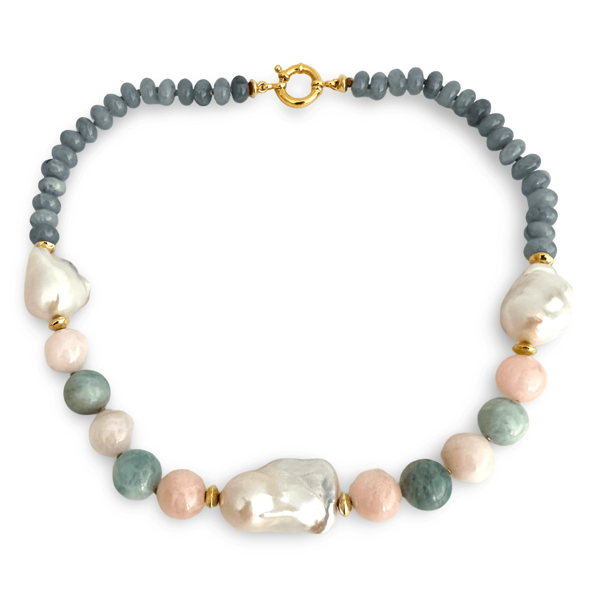 A beaded necklace featuring a strand of slate blue-gray round beads, a large irregular white baroque pearl, several pale pink baroque pearls, and several round sage green baroque pearls, separated by small gold spacer beads and a gold clasp, shown on a plain white background.