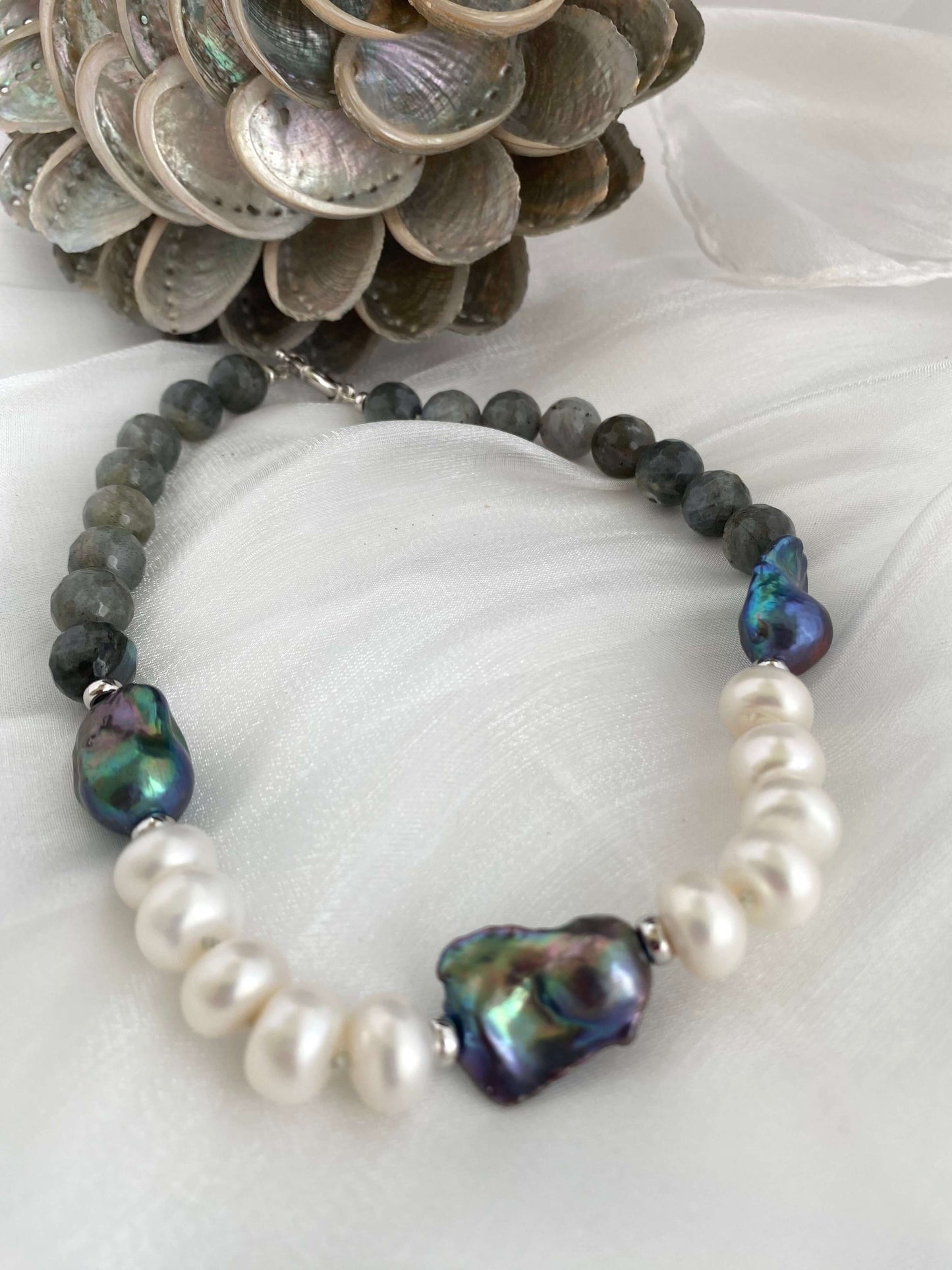Labradorite pearl necklace with baroque and coin pearls showcasing iridescent colors.