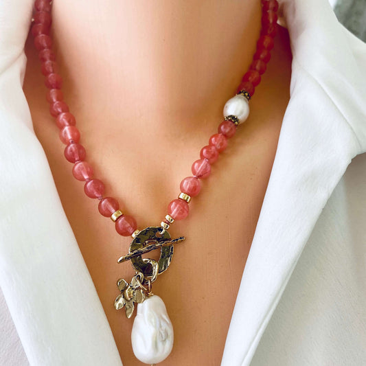 Necklace with red beads and a white pearl pendant on a mannequin