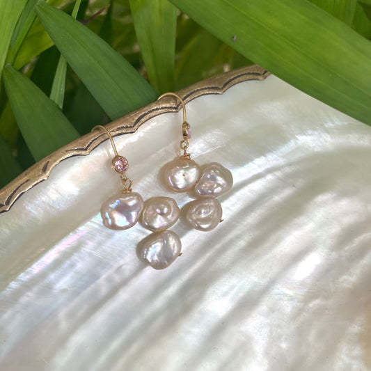 Elegant earrings composed of Natural Keshi pink and white pearls hanging from gold filled hooks with pink cubic zirconia bezel
