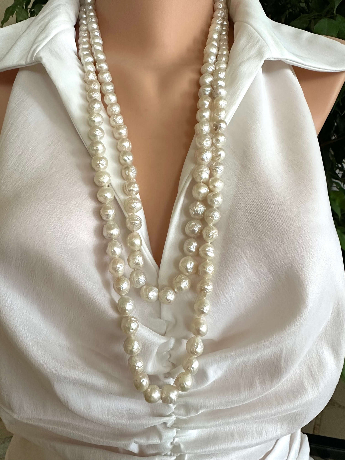 Edison pearl Y necklace featuring handcrafted baroque pearls, styled elegantly on a mannequin.