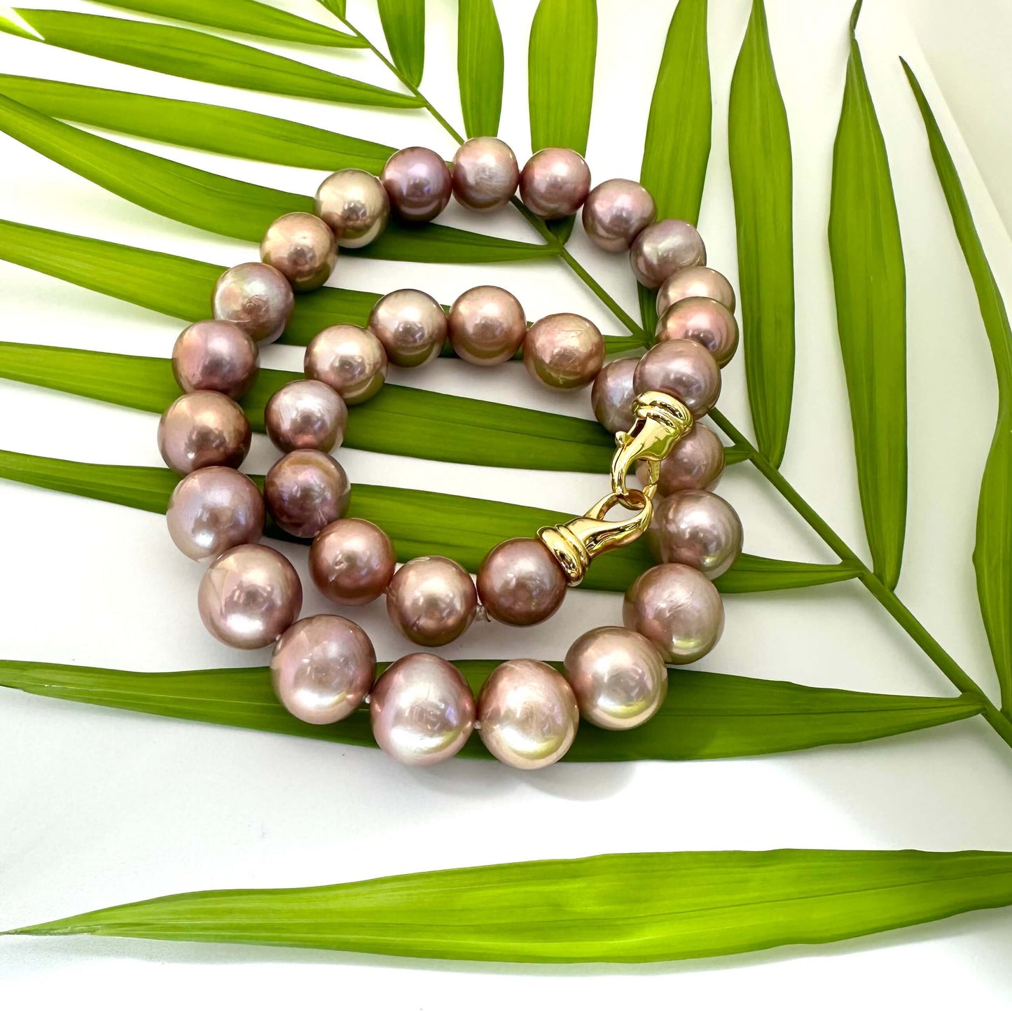 Metallic Edison Pearl Necklace | 12–14mm, 18" handcrafted design with large pearls and gold clasp on tropical leaves.