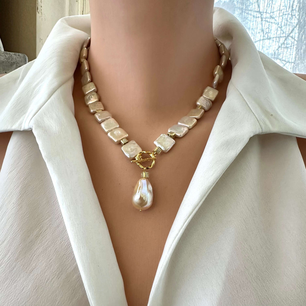 Golden baroque pearl toggle necklace front view on mannequin — classic handcrafted pearl jewelry design by Loulia Pearl Jewelry