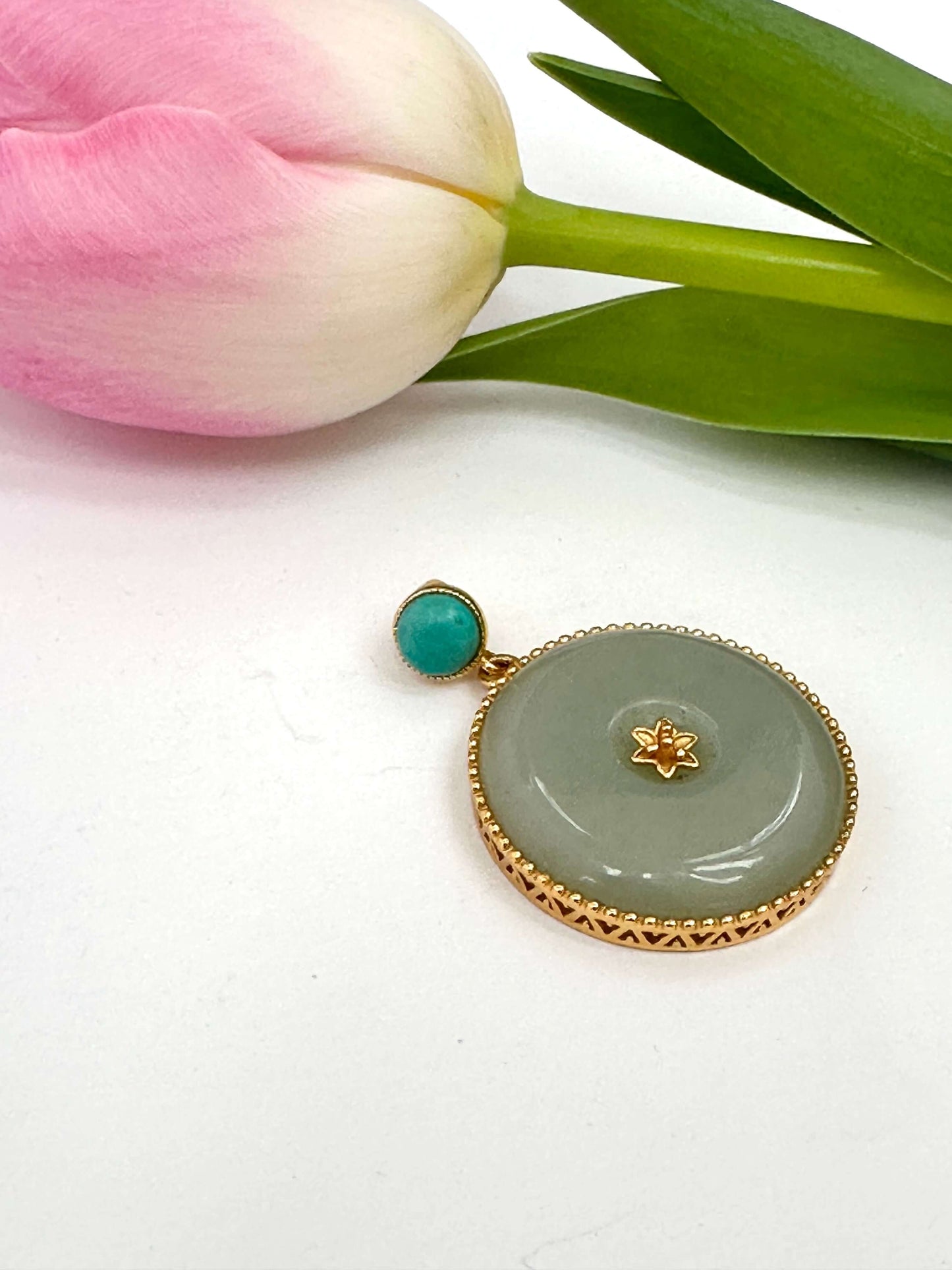 Hotan jade pendant with turquoise accent set in gold vermeil, featuring a polished jade cabochon and delicate turquoise stone.