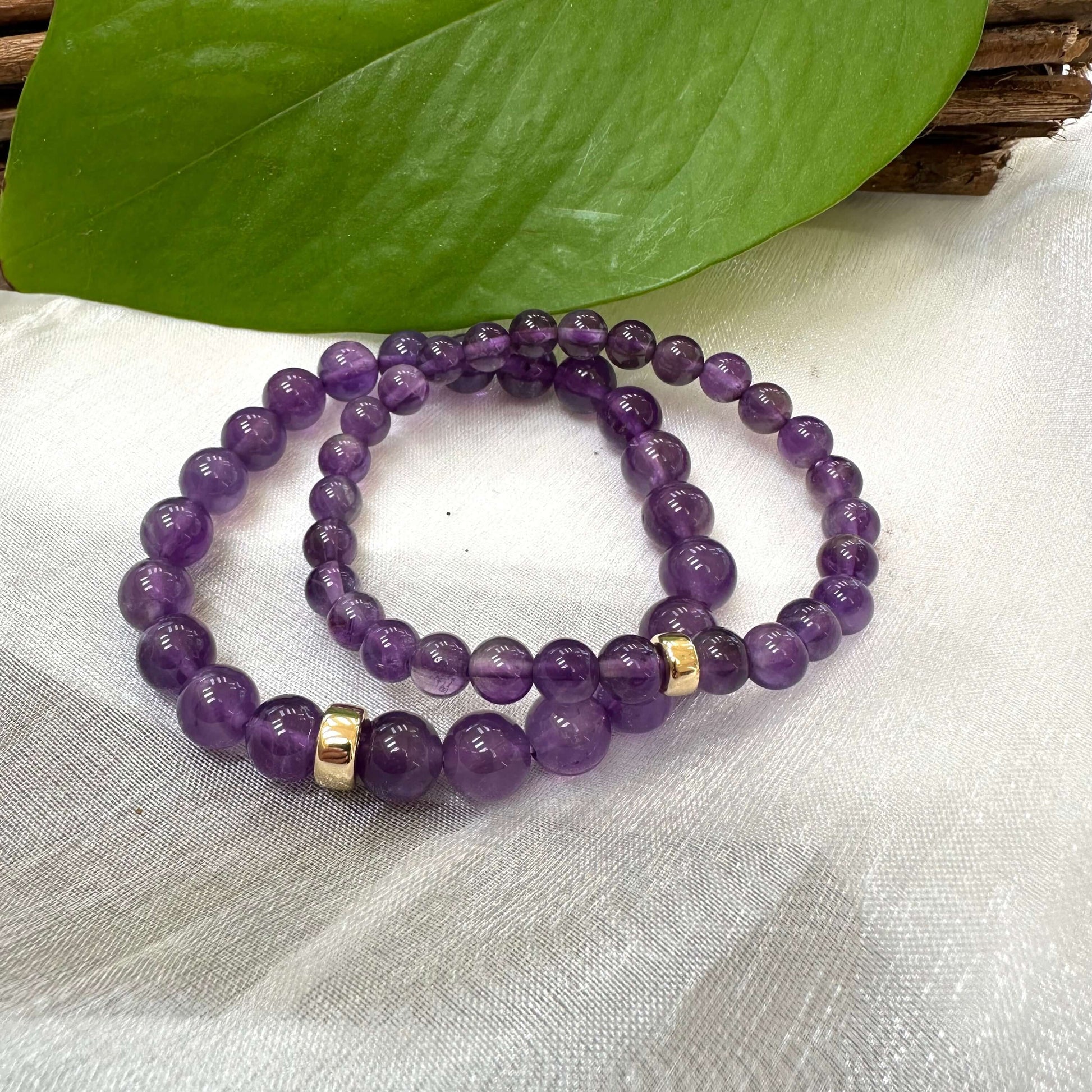 Amethyst Bracelet pair displayed on white cloth – two-bracelet product image