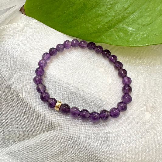 Amethyst Bracelet displayed on white cloth – gemstone bead close-up