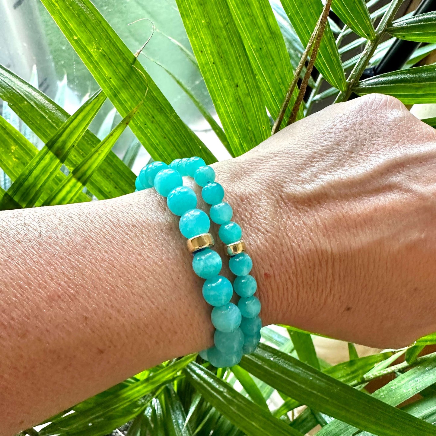Blue Amazonite Bracelet worn on model’s wrist against foliage – lifestyle close-up