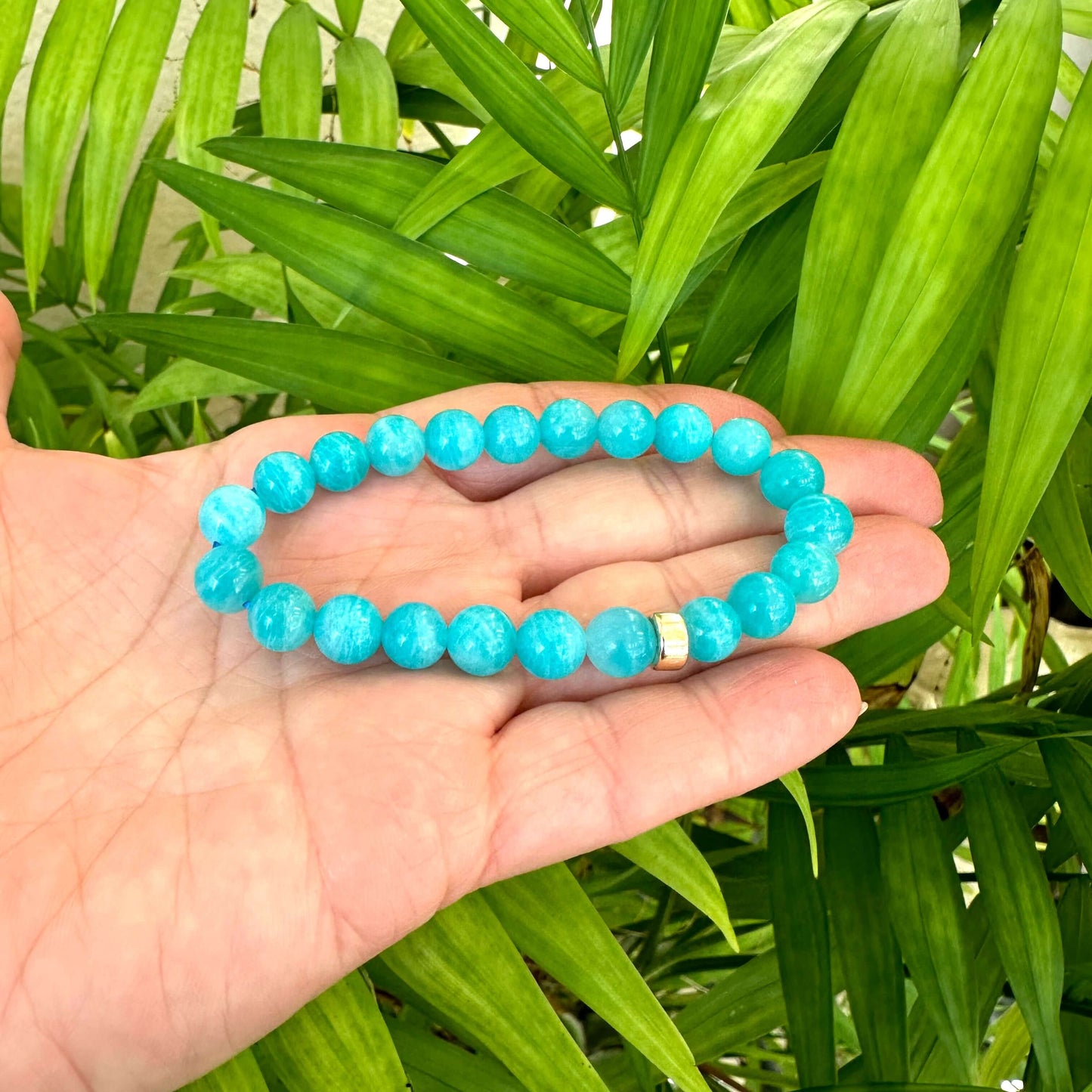 Blue Amazonite Bracelet held in hand – natural light bead texture shot