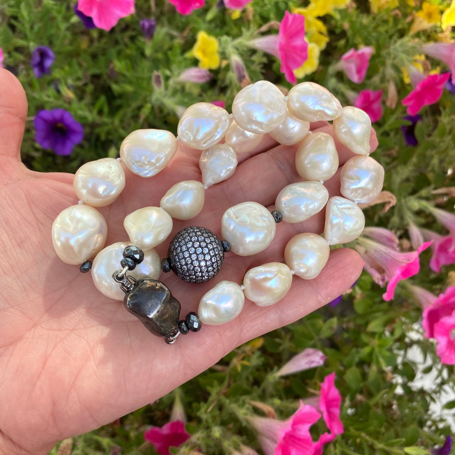 Ivory baroque pearl bridal necklace photographed outdoors emphasizing pearl texture and elegance