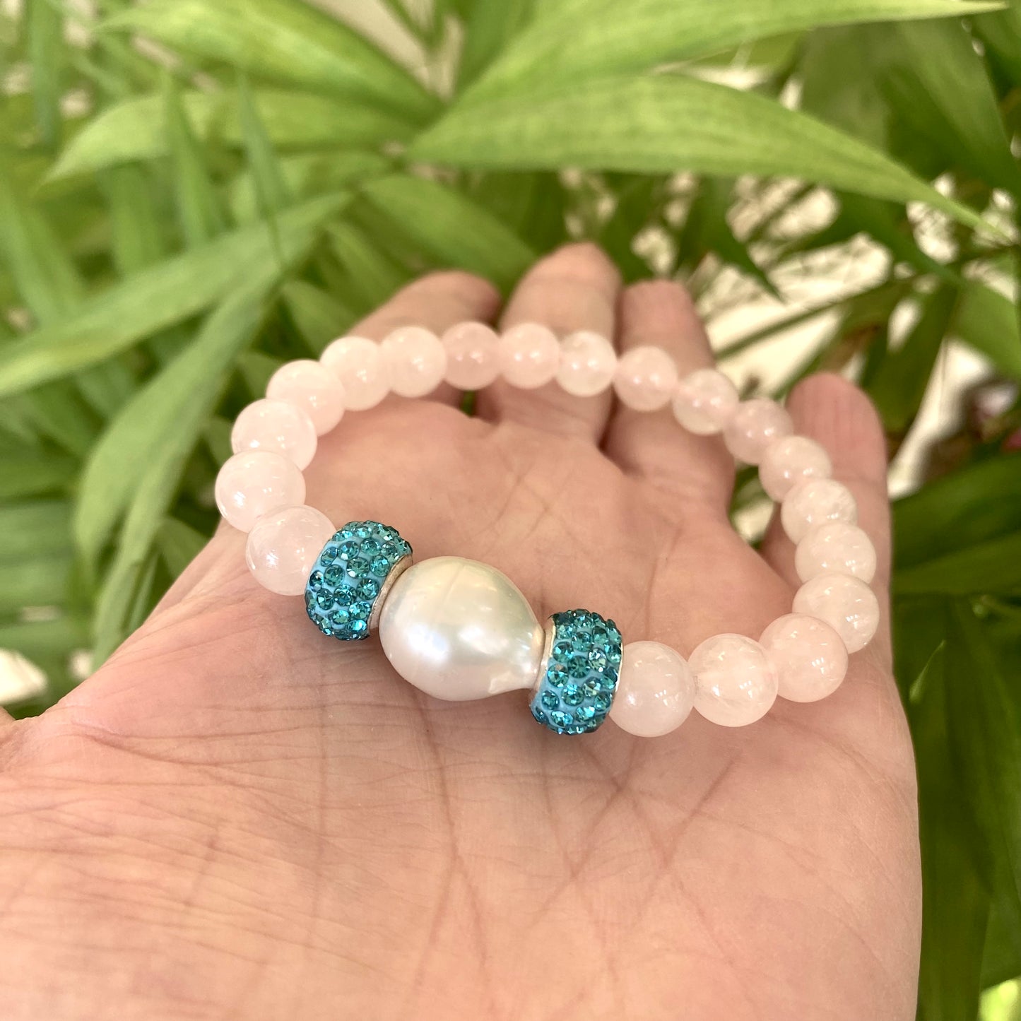 Blue sponge rose quartz pearl stretchy bracelet highlighting rose quartz beads and freshwater pearl