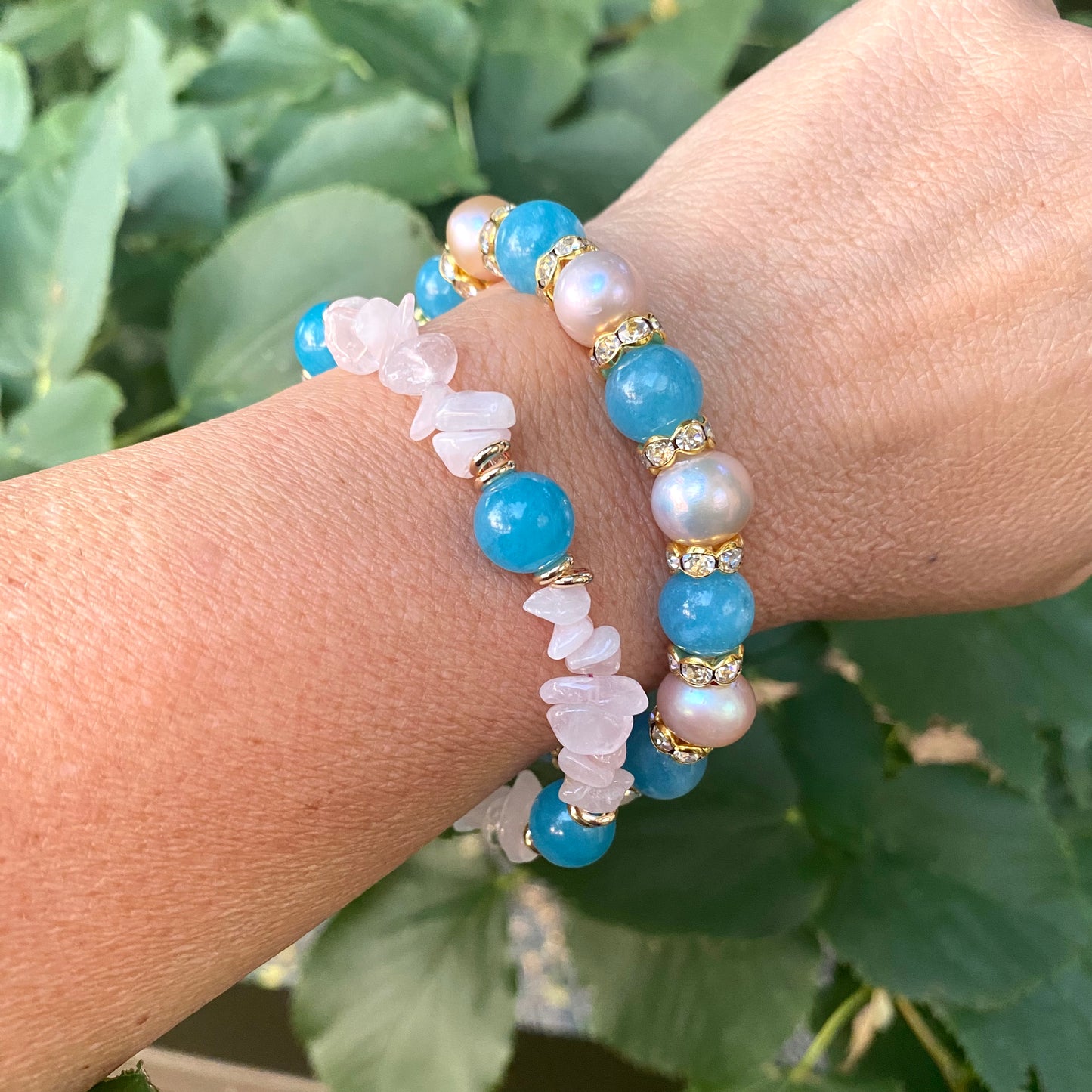 Blue sponge rose quartz pearl stretchy bracelet worn on wrist featuring blue sponge quartz beads