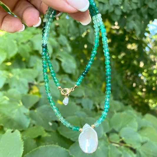 Green onyx keshi pearl necklace held in hand showing faceted beads and keshi pearl pendant