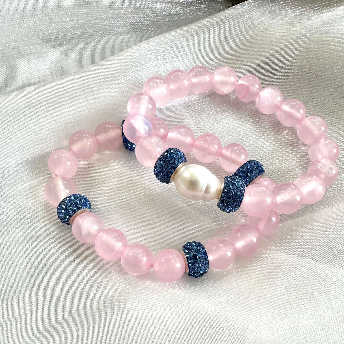 Pink jade bracelet featuring natural 10mm pink jade beads, a freshwater pearl, and rhinestone accents.