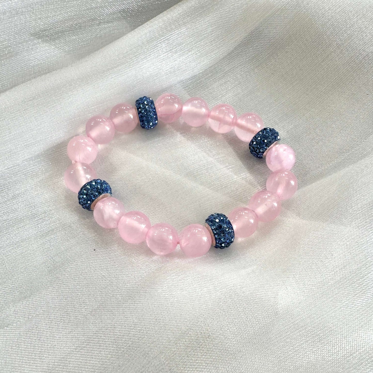 Pink jade bracelet – Handmade stretch bracelet with shimmering rhinestone accents and pink jade beads.