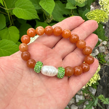 Load image into Gallery viewer, Orange Aventurine Stretch Bracelet with large freshwater pearl and Green Rhinestones Pave Beads in Middle
