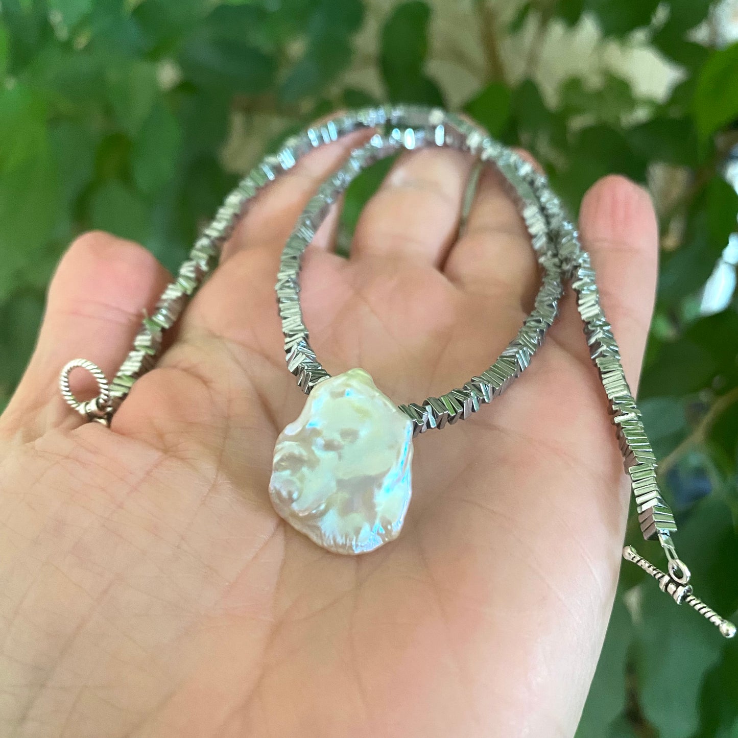 Hematite pearl necklace with keshi pearl pendant close-up