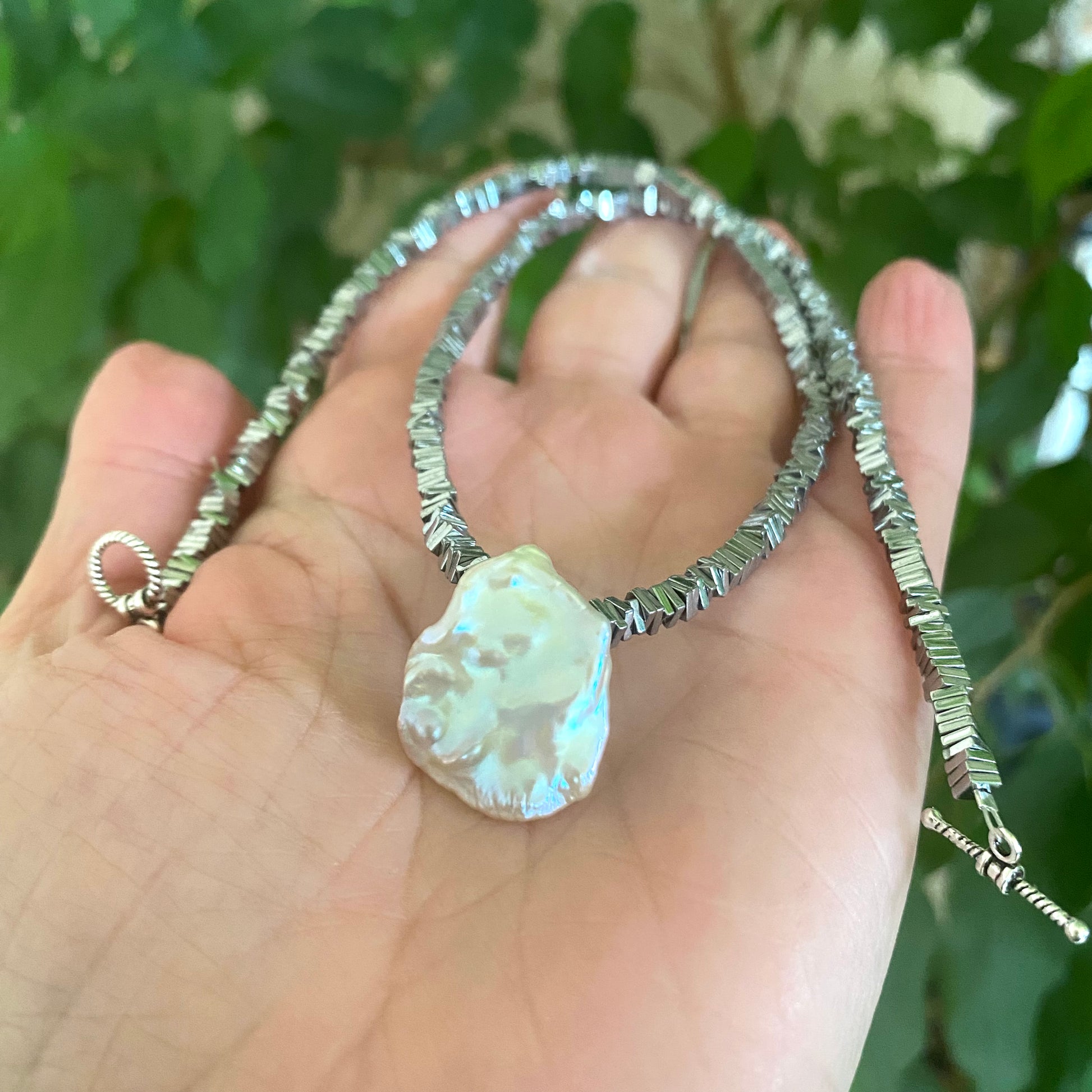 Hematite pearl necklace with keshi pearl pendant close-up