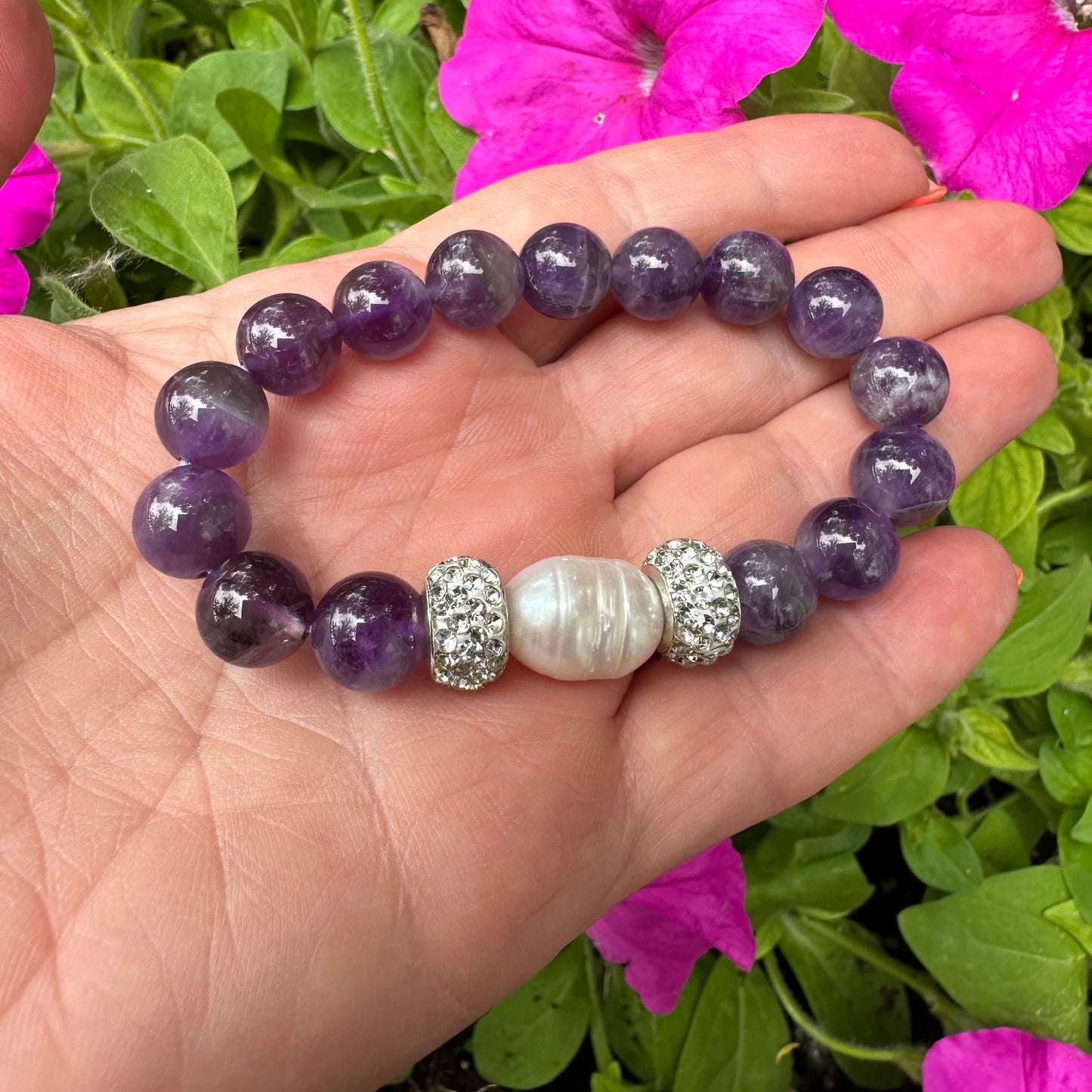 Close up of chevron amethyst bracelet outdoors with greenery