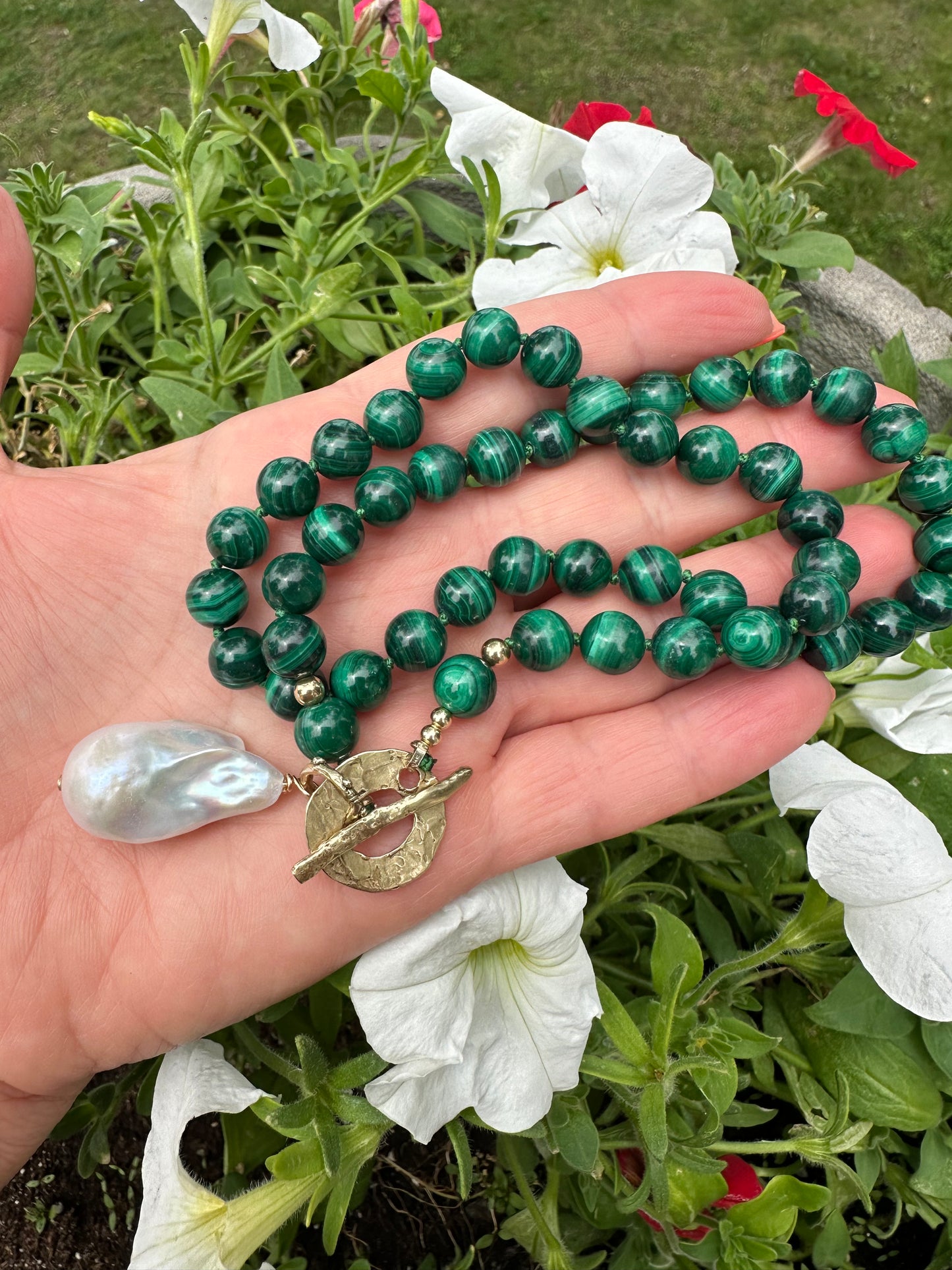 Malachite toggle necklace with baroque pearl pendant, showcasing vibrant green beads and artisan craftsmanship.