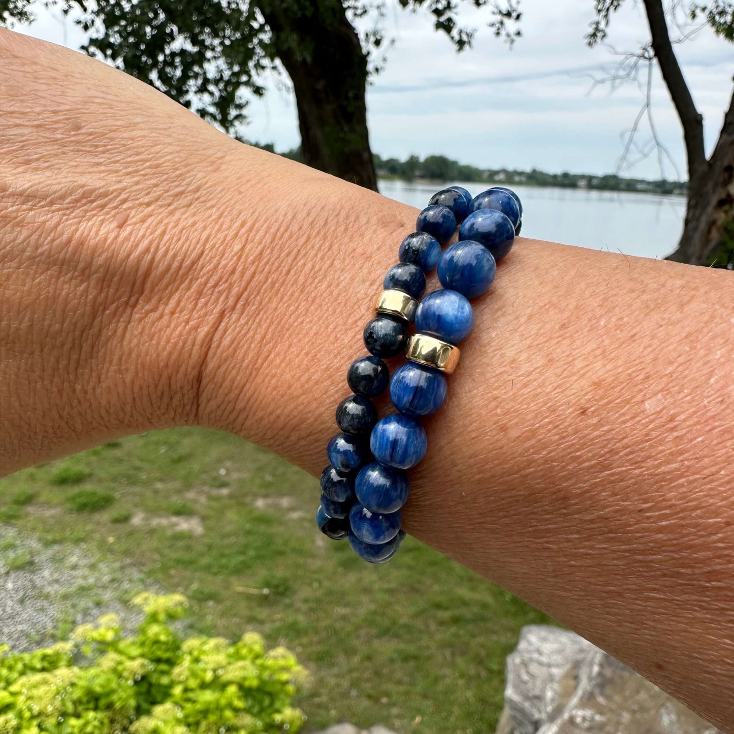 Blue kyanite bracelet worn on female wrist, stacked with another bracelet