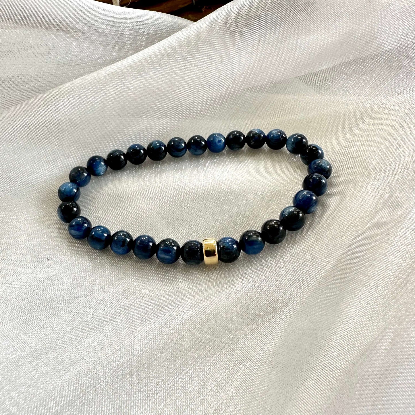 Blue kyanite bracelet displayed on white cloth background