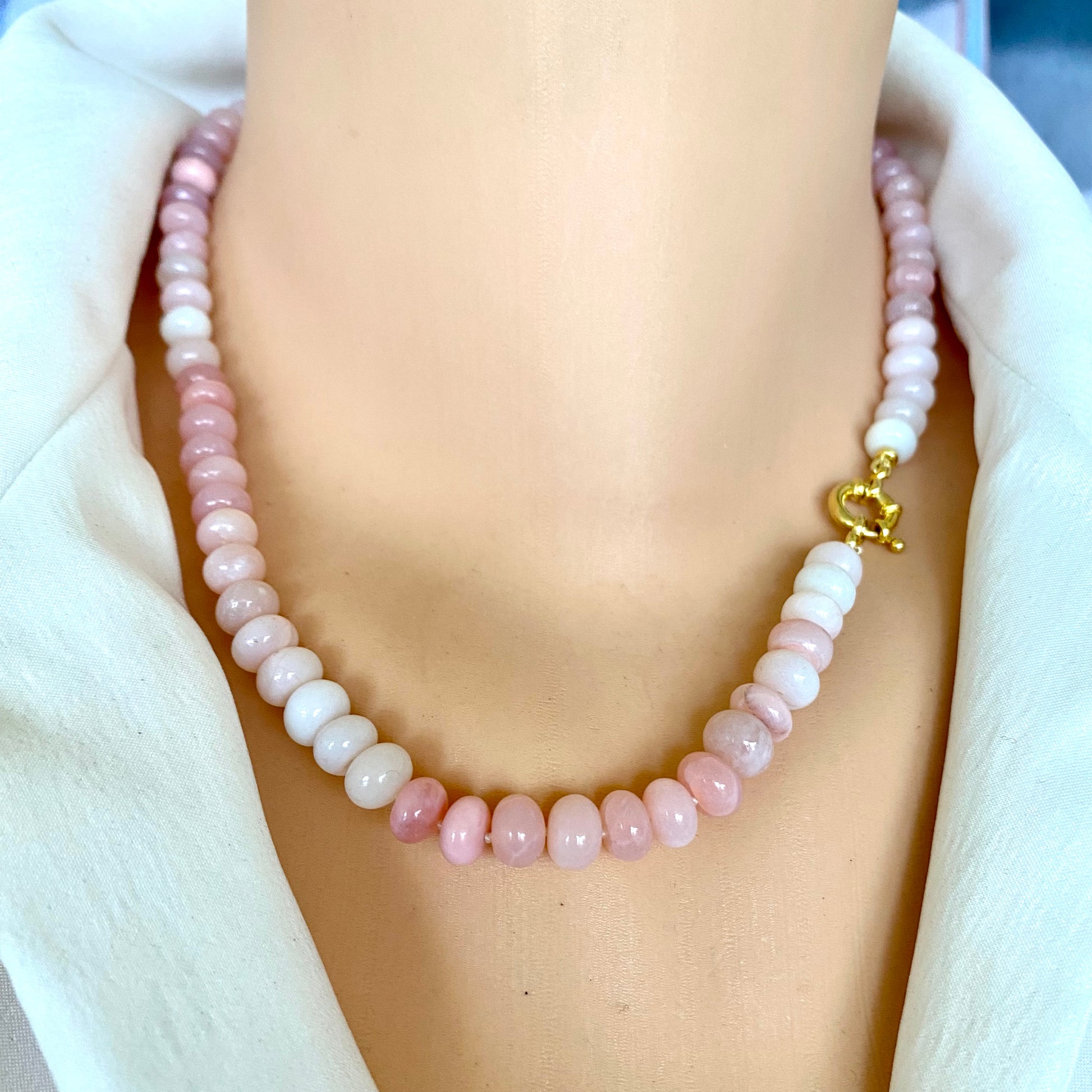 Pink opal beaded necklace worn on mannequin, front close-up